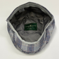 Plaid cap with visible brand label on a white background