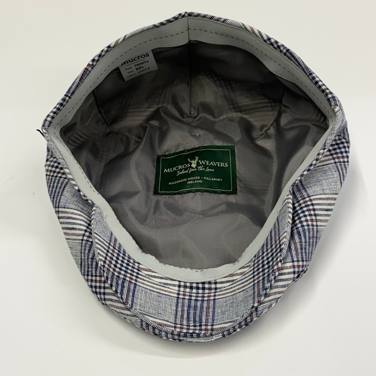 Plaid cap with visible brand label on a white background