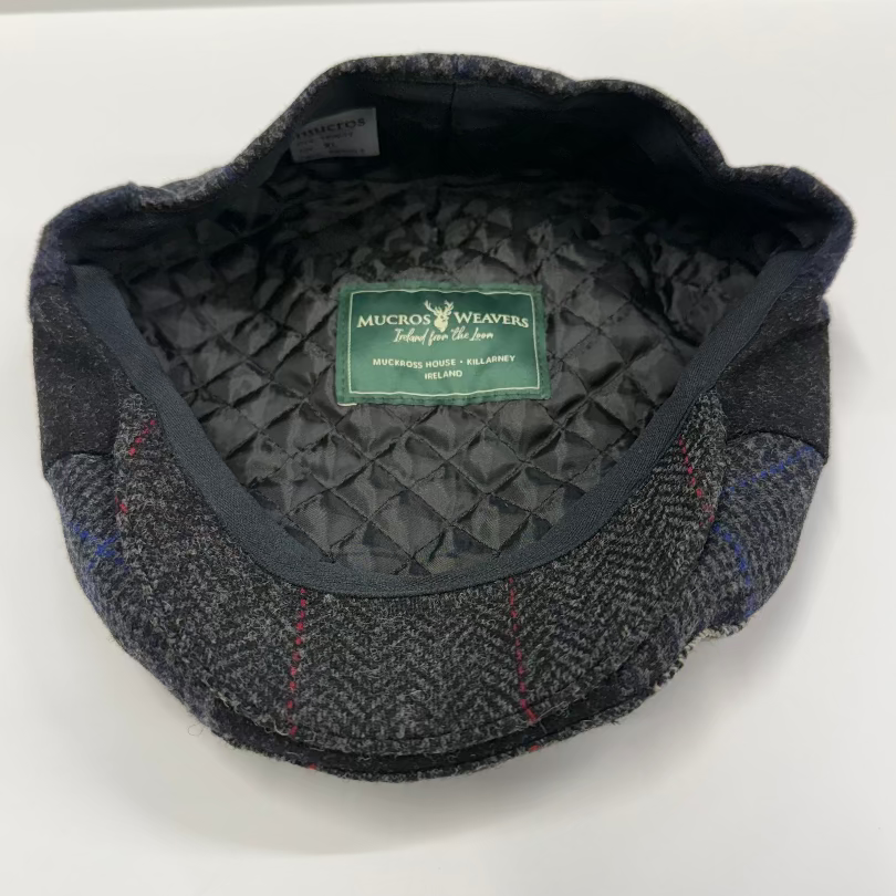 Gray tweed cap with quilted interior and Mucros Weavers label on a white background