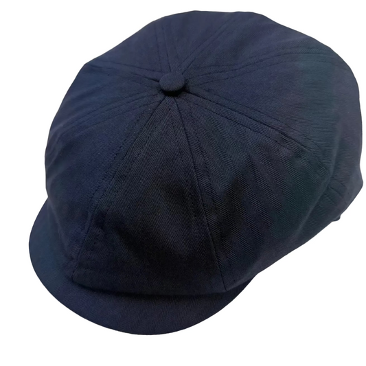 A dark navy blue newsboy cap with a button on top, photographed on a plain white background.