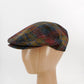 A multicolor plaid tweed flat cap displayed on a light wood mannequin head against a white studio background.