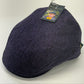 A dark navy blue herringbone tweed flat cap with a hangtag, photographed on a plain white background.