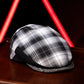 A black and white plaid flat cap resting on a dark wooden surface, with glowing red neon light bars in the background.