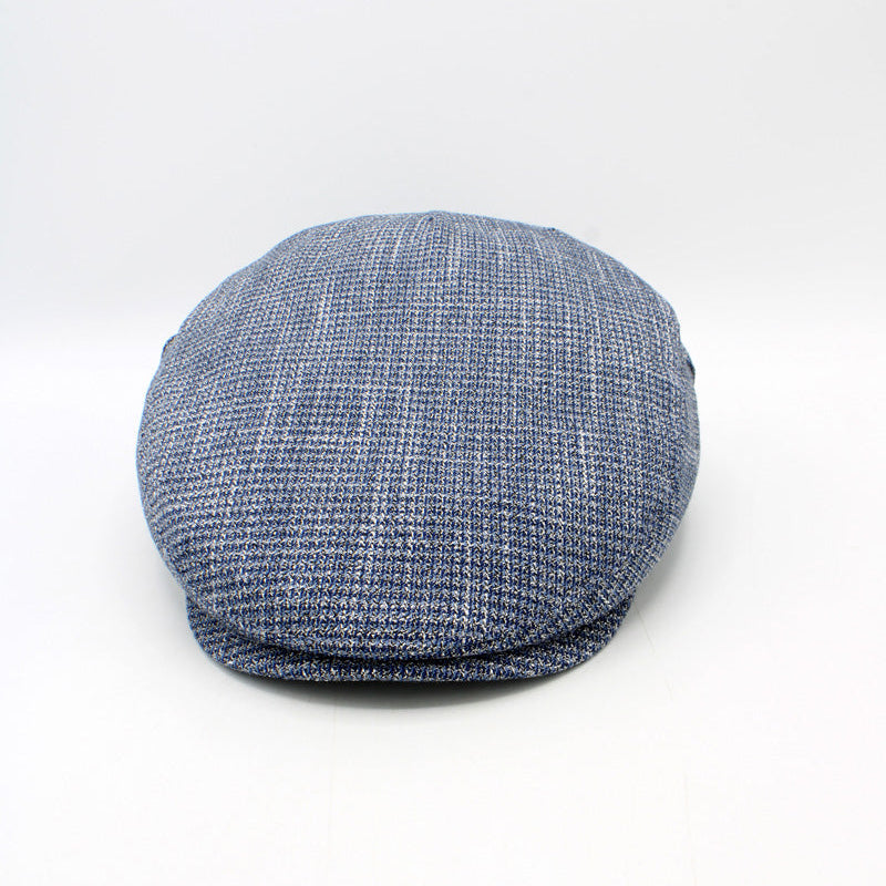 A blue and white textured flat cap, also known as a newsboy cap, shown from a front-three-quarter angle on a white studio background.