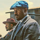 Man in a hot teal newsboy cap.