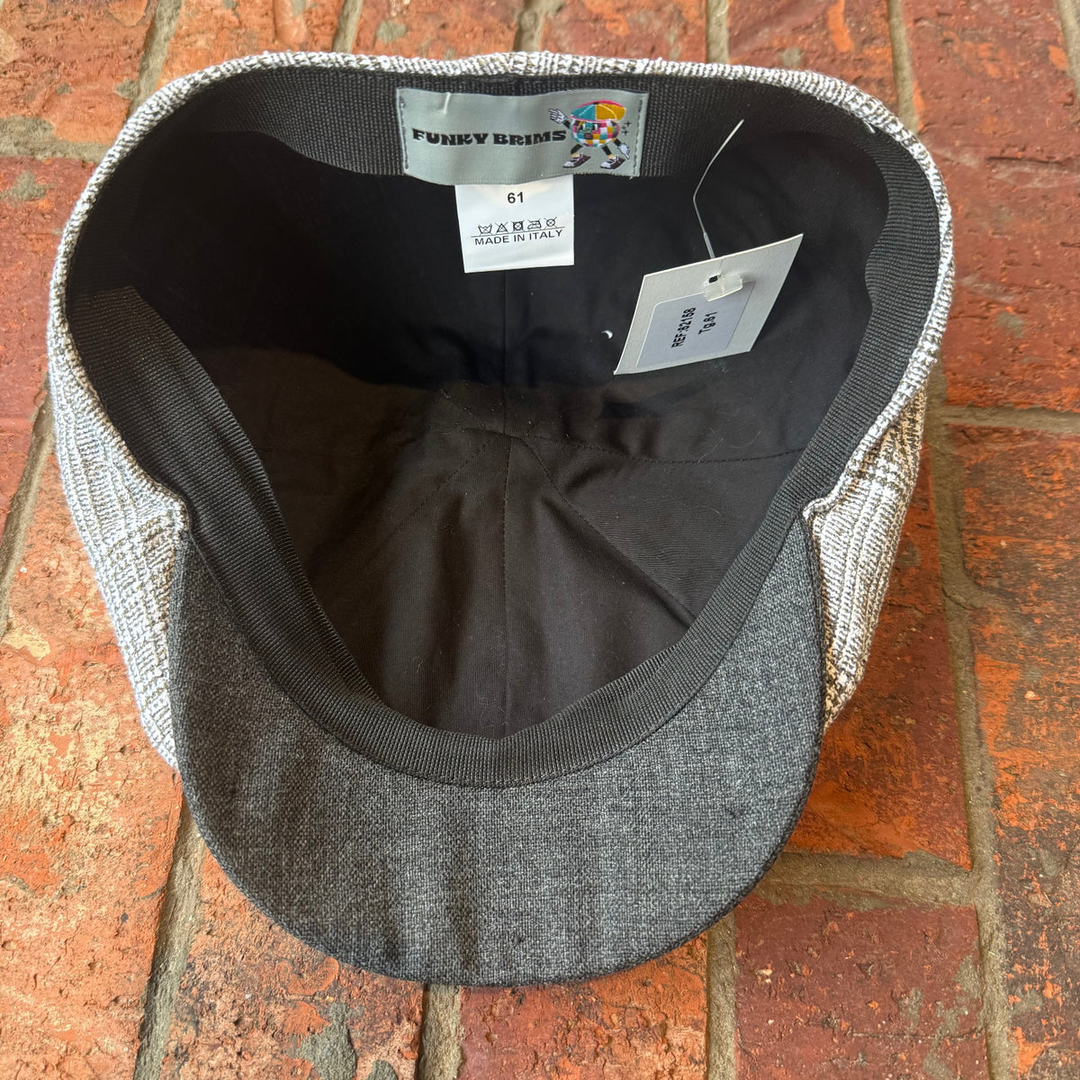 A gray and white textured flat cap with a black interior, shown from the inside. The brand label reads 'Punky Bants' and the size is 61.