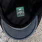Close-up of the inside of a black cap showing a square embroidered patch with a gas mask design and the text 'TOXIC HAZARDS COLLAR'.