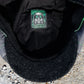 Close-up of the inside of a black cap showing a square patch label with a gas mask graphic and the text 'TOXICITY' and 'HALES COLLAB'.
