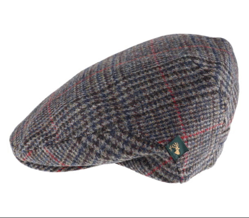 A classic flat cap in a gray and navy blue houndstooth pattern with thin red and yellow windowpane lines, featuring a small green Deerhead brand tag on the side.