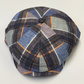 Plaid patterned beret on a light gray background