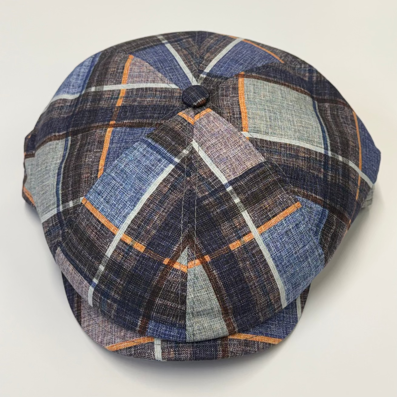 Plaid patterned beret on a light gray background