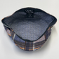 Fabric sample with plaid pattern and 'CAPAS' branding on a white background