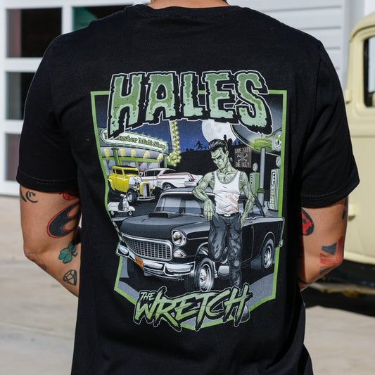 A man wearing a black tee shirt with graphics of A frankenstein next to a car and words "Hales" and "Wretch" on it.