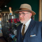 Three-quarter view of a model wearing the da Vinci Fedora by FunkyBrims, with warm brown flecked fabric and a brown ribbon band.