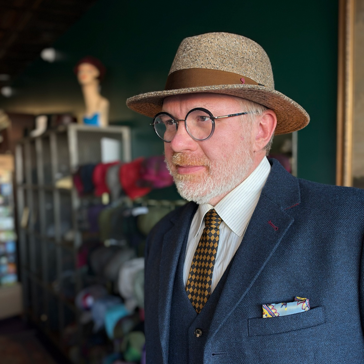 Three-quarter view of a model wearing the da Vinci Fedora by FunkyBrims, with warm brown flecked fabric and a brown ribbon band.