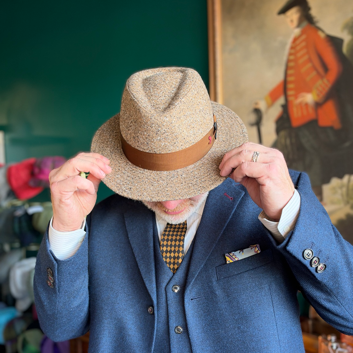 Crown view of the da Vinci Fedora by FunkyBrims as the model holds the brim, showing the shaped crown and brown ribbon band.