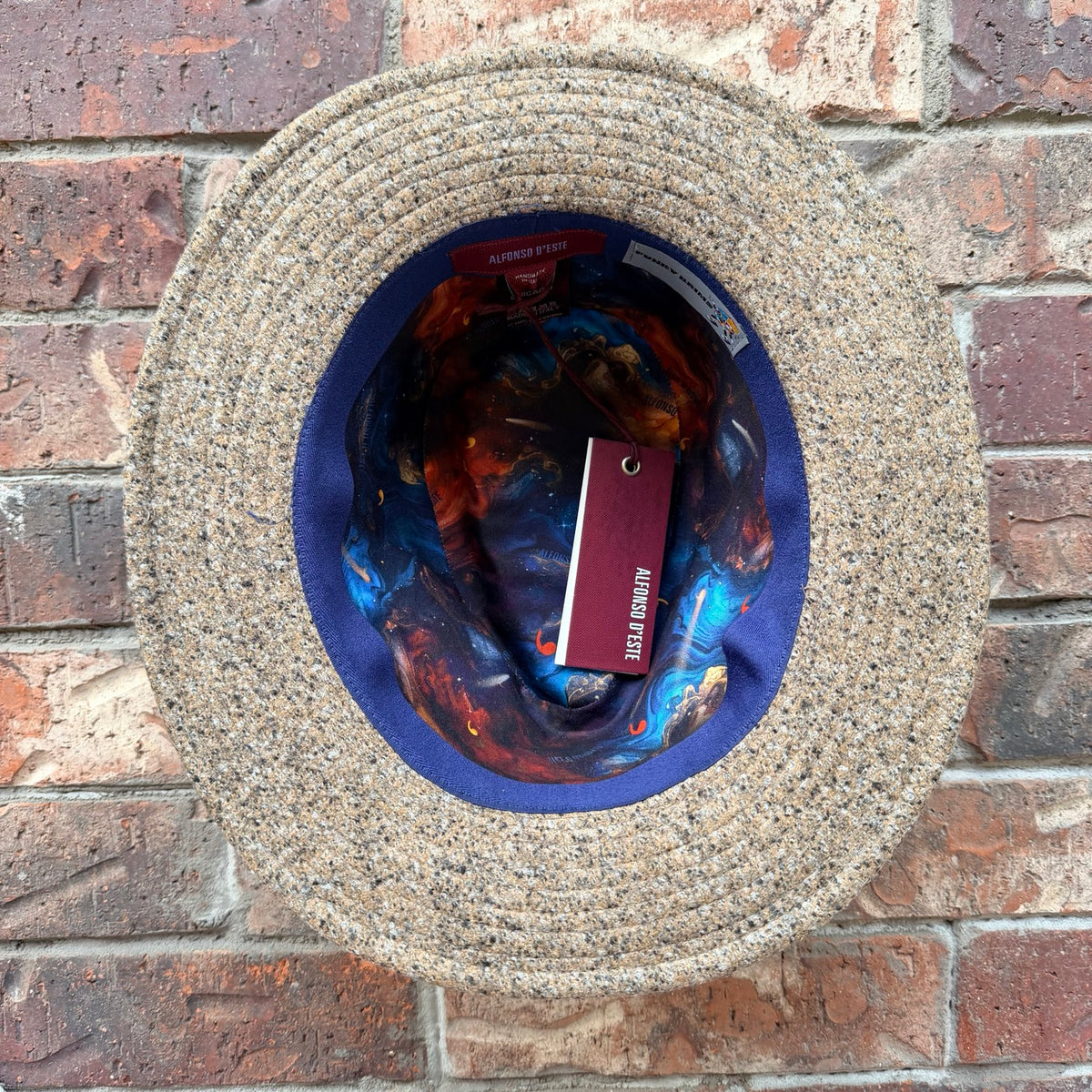Interior view of the Masterpiece da Vinci Fedora by FunkyBrims, showing its colorful illustrated lining.