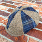 Three-quarter product view of the Masterpiece da Vinci Newsboy Cap by FunkyBrims with alternating flecked and navy plaid panels.