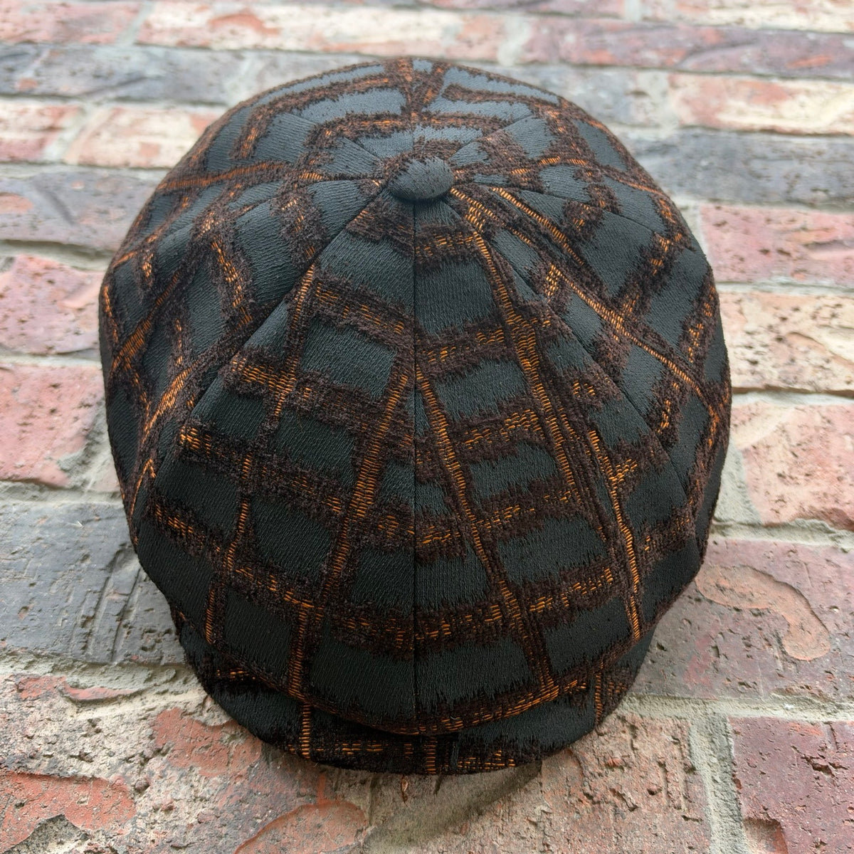 RazorClaw black and orange newsboy cap, front view
