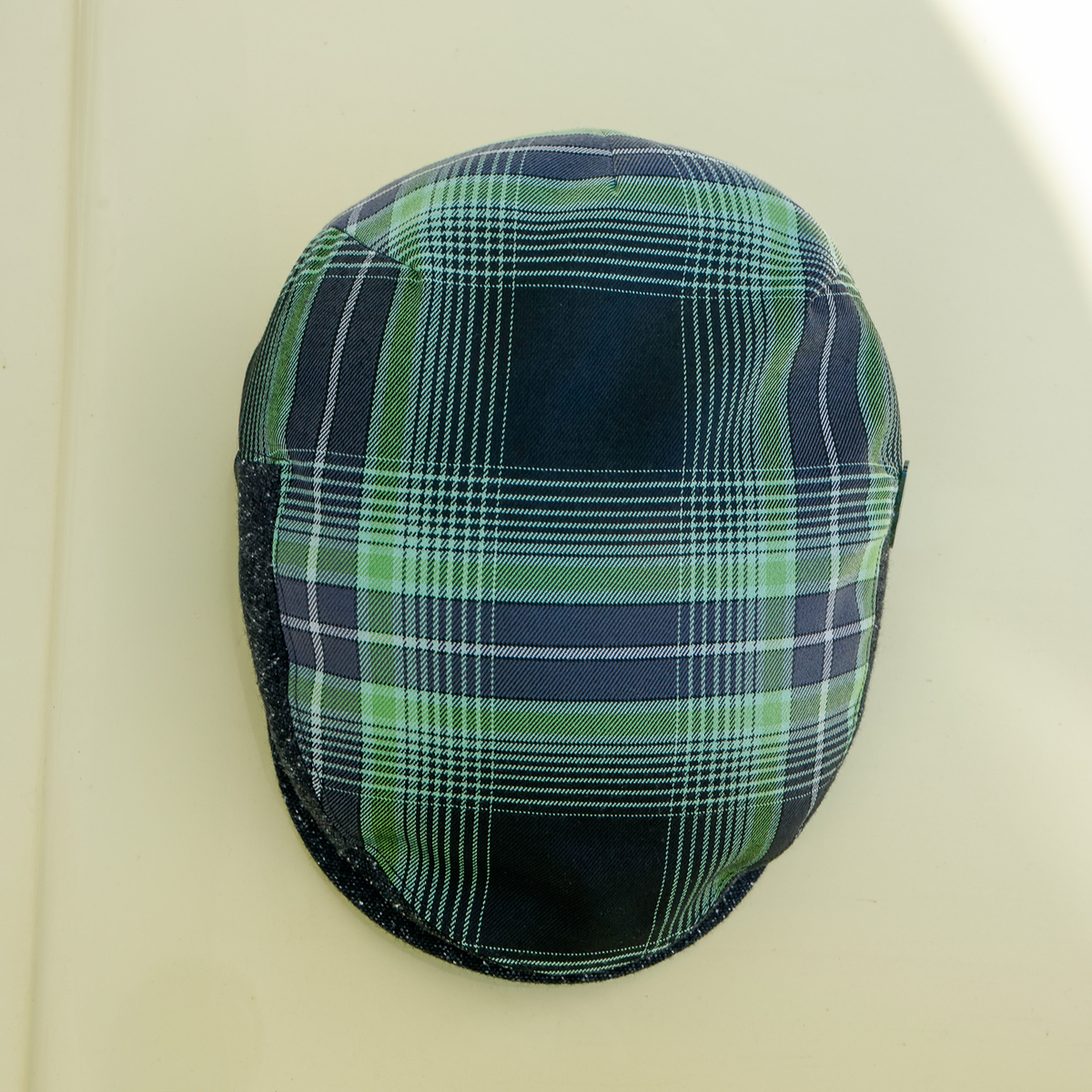 Wretch flannel flat cap, top view of the green and black plaid