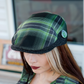 Wretch flannel flat cap worn with included Frankenstein enamel pin
