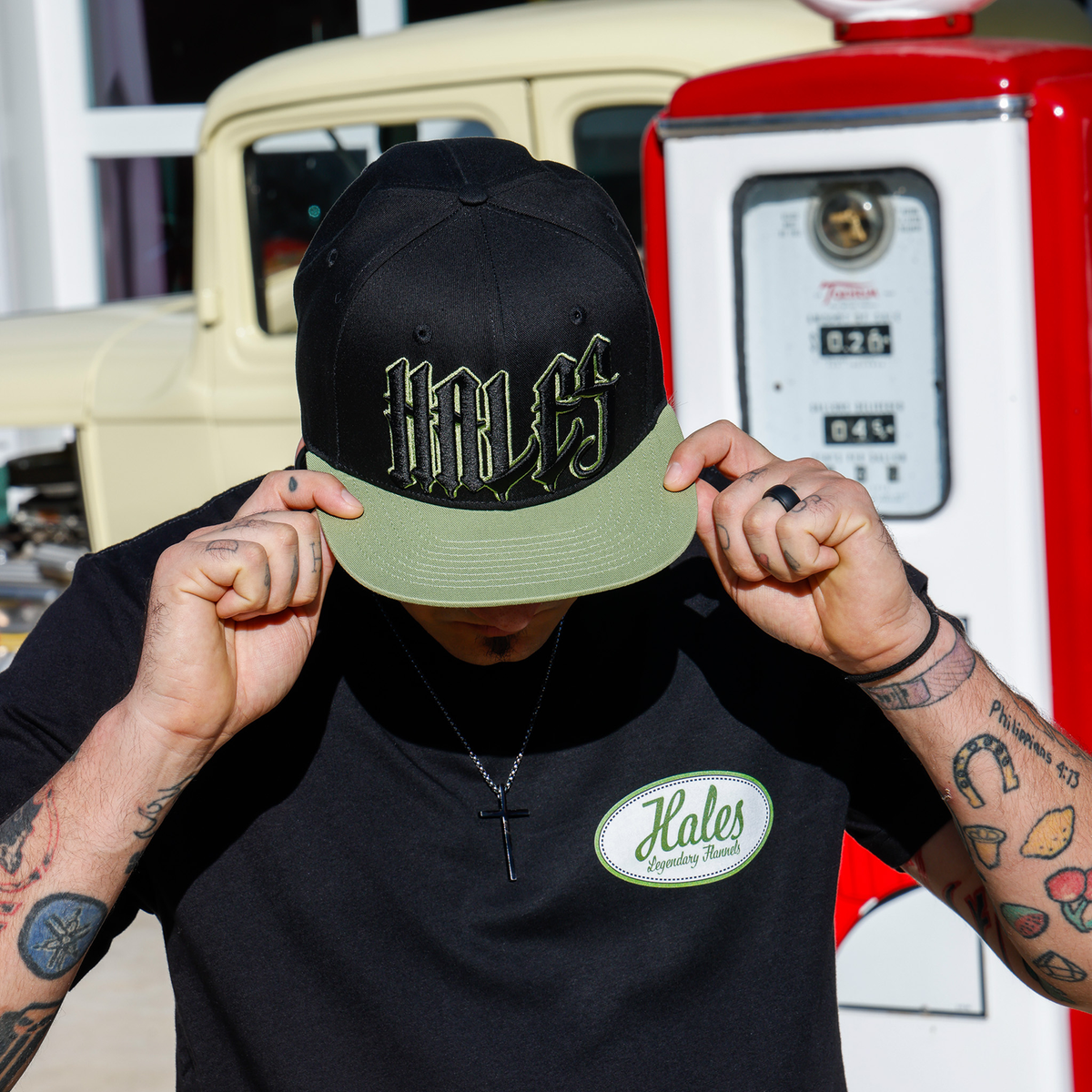 Model wearing the Wretch snapback and black Wretch tee