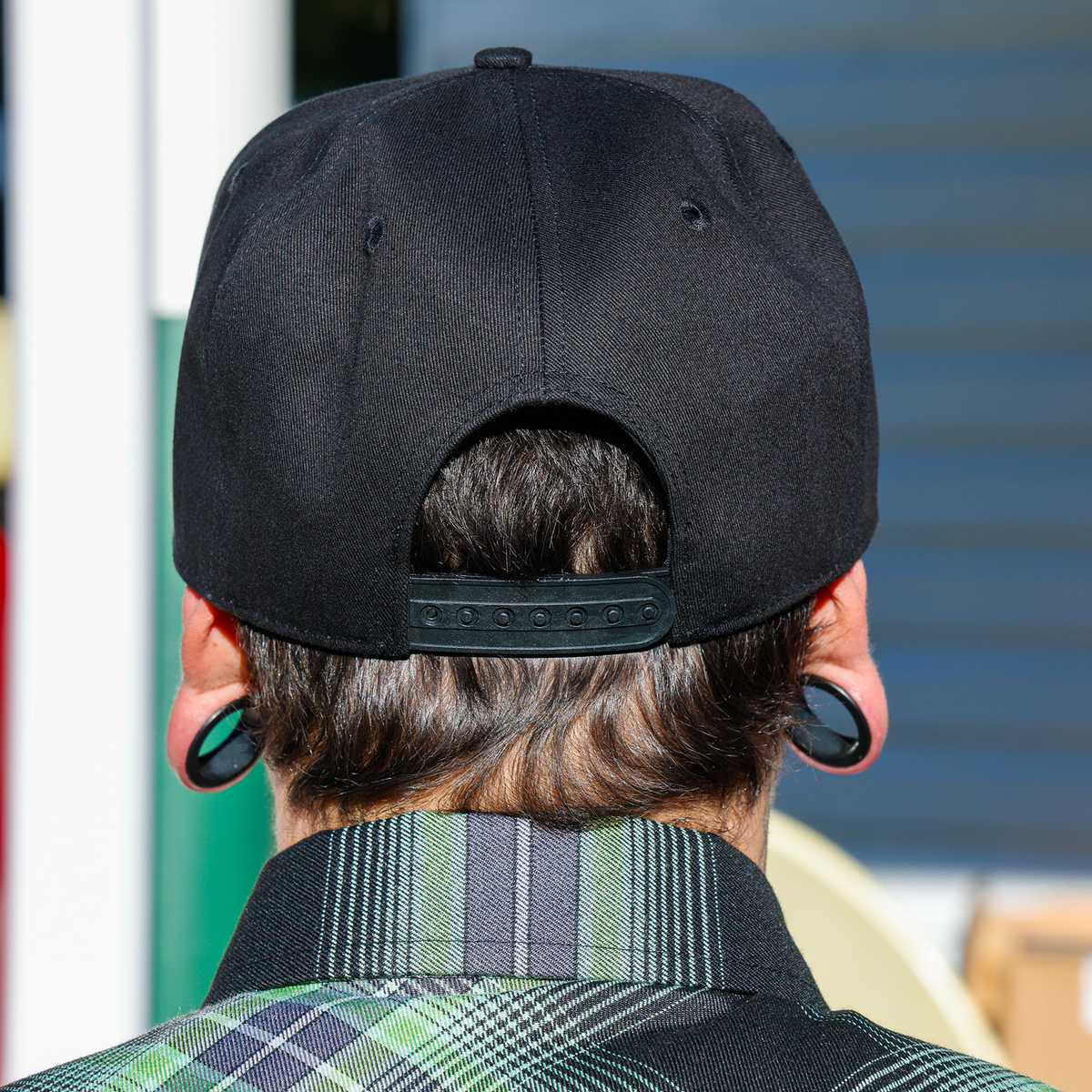 Wretch snapback, back view showing adjustable black closure